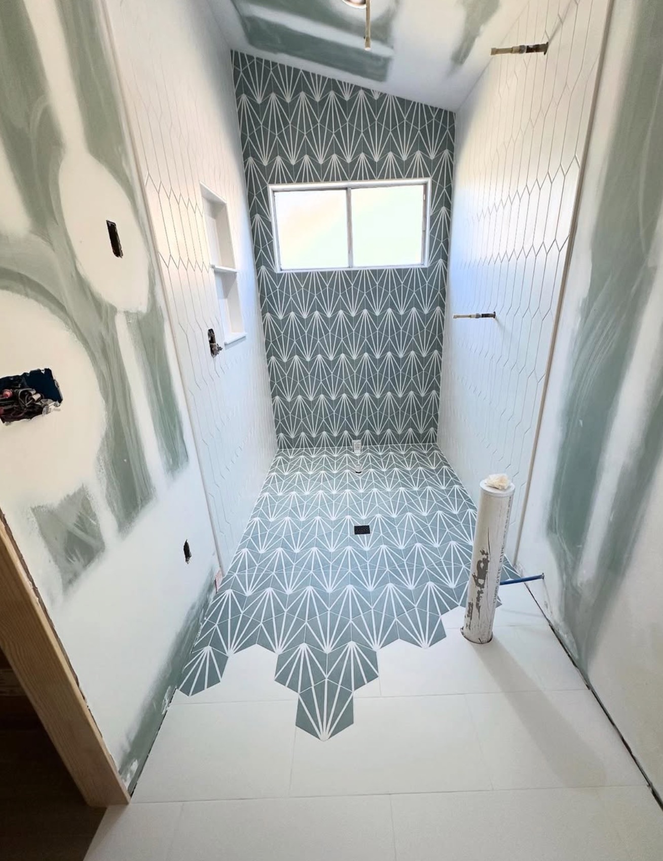Custom shower with patterned green tile accent